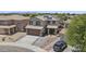 Two-story home featuring a well-manicured front yard, a two car garage, and solar panels on the roof at 13160 W Windsor Ave, Goodyear, AZ 85395