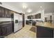 Well-equipped kitchen featuring modern appliances, dark cabinetry, and a functional layout for cooking and entertaining at 13160 W Windsor Ave, Goodyear, AZ 85395