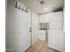 This practical laundry room offers a stacked washer and dryer, storage, and sink at 13160 W Windsor Ave, Goodyear, AZ 85395