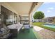 Inviting covered patio with comfortable seating, perfect for relaxing and enjoying the outdoor view of the pool at 13160 W Windsor Ave, Goodyear, AZ 85395
