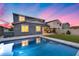 Inviting backyard with a pool, turf, and covered patio for outdoor living and entertaining at 13237 W Redstone Dr, Peoria, AZ 85383