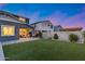 The backyard has green grass, a covered patio, an outdoor grill, and a firepit, perfect for entertaining at 13237 W Redstone Dr, Peoria, AZ 85383