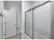 This bathroom features a glass-enclosed shower, white cabinets, and tile flooring at 13237 W Redstone Dr, Peoria, AZ 85383