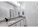Well-lit bathroom featuring a granite countertop, a modern sink, and white cabinetry at 13237 W Redstone Dr, Peoria, AZ 85383