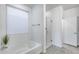 Bright bathroom with a soaking tub, glass shower, and modern fixtures at 13237 W Redstone Dr, Peoria, AZ 85383