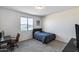 This bedroom features neutral walls, a large window, plush carpeting, and a gray upholstered bed frame at 13237 W Redstone Dr, Peoria, AZ 85383