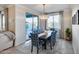 Elegant dining room with stylish chairs, chandelier lighting, and access to the backyard at 13237 W Redstone Dr, Peoria, AZ 85383