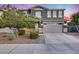 Beautiful two-story home with a gray exterior, well-kept landscaping and a spacious two car garage at 13237 W Redstone Dr, Peoria, AZ 85383