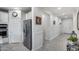 Hallway leading into kitchen area showing appliances and wainscoting detail, and a modern refrigerator at 13237 W Redstone Dr, Peoria, AZ 85383
