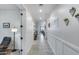 Long and inviting hallway featuring light walls, tile flooring and decorative accents at 13237 W Redstone Dr, Peoria, AZ 85383