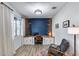 Contemporary home office with built-in desk, modern chair, accent wall, and stylish decor with bright lighting at 13237 W Redstone Dr, Peoria, AZ 85383