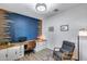 Bright home office featuring custom built-ins, stylish décor, and modern finishes with blue accent wall at 13237 W Redstone Dr, Peoria, AZ 85383