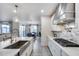 Chef's kitchen boasts white cabinets, modern stainless steel hood, and a marble backsplash at 13237 W Redstone Dr, Peoria, AZ 85383