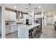 Modern kitchen featuring white cabinetry, stainless steel appliances, a quartz countertop island with seating at 13237 W Redstone Dr, Peoria, AZ 85383
