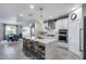 Modern kitchen features white cabinetry, stainless steel appliances, a large island and barstool seating at 13237 W Redstone Dr, Peoria, AZ 85383