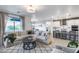 Open-concept living space boasts a large sectional, sleek lighting, and seamless flow to the kitchen at 13237 W Redstone Dr, Peoria, AZ 85383