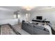 Inviting living room with a large gray sofa and wall-mounted television for modern comfort at 13237 W Redstone Dr, Peoria, AZ 85383