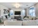 Bright living room features neutral tones, stylish furnishings, and large windows with elegant curtains at 13237 W Redstone Dr, Peoria, AZ 85383