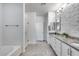 Elegant bathroom with white cabinetry, granite counters, shower, and tile floors at 13237 W Redstone Dr, Peoria, AZ 85383