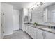 Beautiful bathroom with double sinks, granite counters, and textured accent wall at 13237 W Redstone Dr, Peoria, AZ 85383