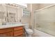 Well-lit bathroom featuring a vanity, toilet, and shower with glass doors at 15452 W Skyview Way, Surprise, AZ 85374
