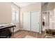 Cozy bedroom with wood floors, natural light, and a sliding door closet at 15452 W Skyview Way, Surprise, AZ 85374