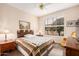 Bright bedroom with a large window, ceiling fan, and wood flooring at 15452 W Skyview Way, Surprise, AZ 85374