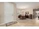 Dining room with a round table and a neutral color palette leading to the front door at 15452 W Skyview Way, Surprise, AZ 85374