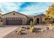 Beautiful single Gathering home with a desert landscape in front and a two-car garage at 15452 W Skyview Way, Surprise, AZ 85374