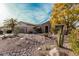 The home features desert landscaping in the front with a palm tree and natural stone at 15452 W Skyview Way, Surprise, AZ 85374