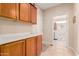 Hallway with kitchen cabinets leading to the laundry room at 15452 W Skyview Way, Surprise, AZ 85374