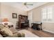 Comfortable home office space featuring a wooden desk, natural light, and a ceiling fan at 15452 W Skyview Way, Surprise, AZ 85374