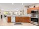 Well-equipped kitchen featuring an open layout, breakfast bar, stainless steel appliances, and tile floors at 15452 W Skyview Way, Surprise, AZ 85374