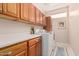 Functional laundry room featuring modern washer and dryer with storage space at 15452 W Skyview Way, Surprise, AZ 85374