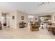 Open-concept living room with neutral colors and a view into the dining room at 15452 W Skyview Way, Surprise, AZ 85374