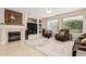 Cozy living room featuring a fireplace, built-ins, and comfortable seating at 15452 W Skyview Way, Surprise, AZ 85374