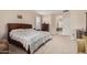 Spacious main bedroom features an ensuite, neutral carpeting, ample space and a stately bed at 15452 W Skyview Way, Surprise, AZ 85374