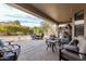 Inviting covered patio features comfortable seating, BBQ, and well-maintained landscaping for outdoor enjoyment at 15452 W Skyview Way, Surprise, AZ 85374