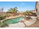 Private backyard featuring a lagoon-style pool, mature palm trees, and an outdoor bar at 15634 S 31St St, Phoenix, AZ 85048