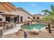 Lush backyard with a uniquely-shaped pool, desert landscaping, and comfortable outdoor seating at 15634 S 31St St, Phoenix, AZ 85048