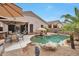 Lush backyard with a uniquely-shaped pool, desert landscaping, and comfortable outdoor seating at 15634 S 31St St, Phoenix, AZ 85048