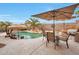 Outdoor entertaining space with a built-in grill, seating area, and a lagoon style pool with a palapa at 15634 S 31St St, Phoenix, AZ 85048