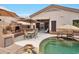 Relaxing backyard oasis with a custom pool, outdoor kitchen, and covered seating area at 15634 S 31St St, Phoenix, AZ 85048