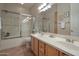 Bathroom with a double sink vanity, framed mirror, and glass enclosed shower at 15634 S 31St St, Phoenix, AZ 85048