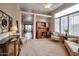Spacious living area with natural light, neutral carpeting, desk area, and access to other rooms at 15634 S 31St St, Phoenix, AZ 85048