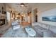 Open-concept living room with fireplace, view into the kitchen, and plush furnishings at 15634 S 31St St, Phoenix, AZ 85048