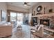 Comfortable living room with a stone fireplace, plush seating, and a seamless transition to the outdoor patio at 15634 S 31St St, Phoenix, AZ 85048