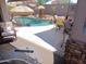 Covered patio with ample seating overlooking the pool, outdoor bar and lounge area at 15634 S 31St St, Phoenix, AZ 85048