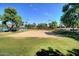 A vibrant sand volleyball court invites friendly competition on a sunny day, surrounded by lush greenery at 15634 S 31St St, Phoenix, AZ 85048