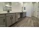 Bathroom with double vanity sinks, wood-look tile floors and modern finishes at 15794 W Cheryl Dr, Waddell, AZ 85355